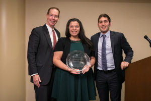 Photo of Dean Mark Nelson and Andrés Quintanilla, MBA ’18, present Adrienne Martinez ’01, MBA ’08 (center), with the Carlos R. Quintanilla Distinguished Latino/Latina Alumni Award