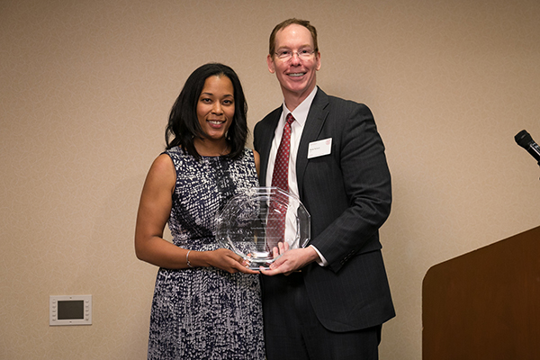 Dean Mark Nelson presents Tyeise Huntley Jones, MBA ’10, with the Wilbur Parker Distinguished Alumni Award