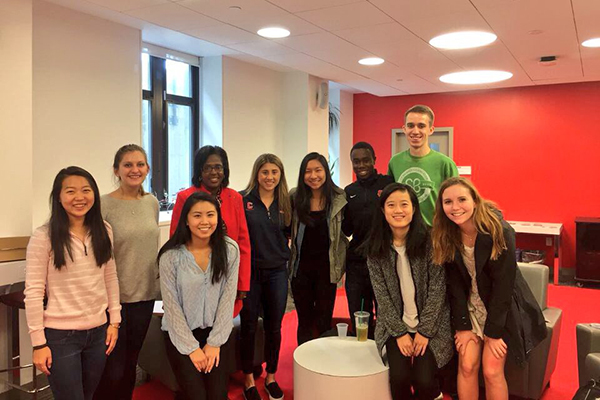 Dyson Dean Lynn Wooten takes a photo with students