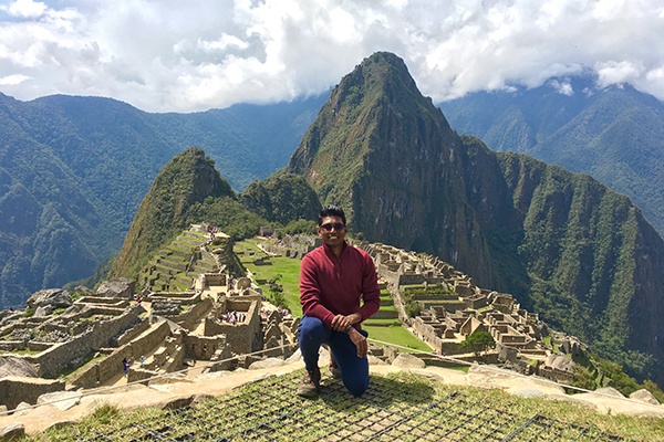 Photo of Mani Selvam, MBA ’18, at Machu Picchu, Peru marveling at the 15th century Incan Citadel in the Andes Mountains during fall break.