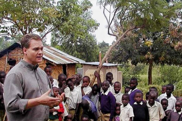 Photo of Chris Barrett with children in Africa. Credit: Chris Barrett