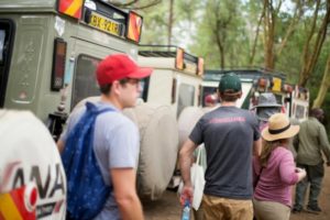 Photo of MBAs getting ready to get into Jeeps for their African safari