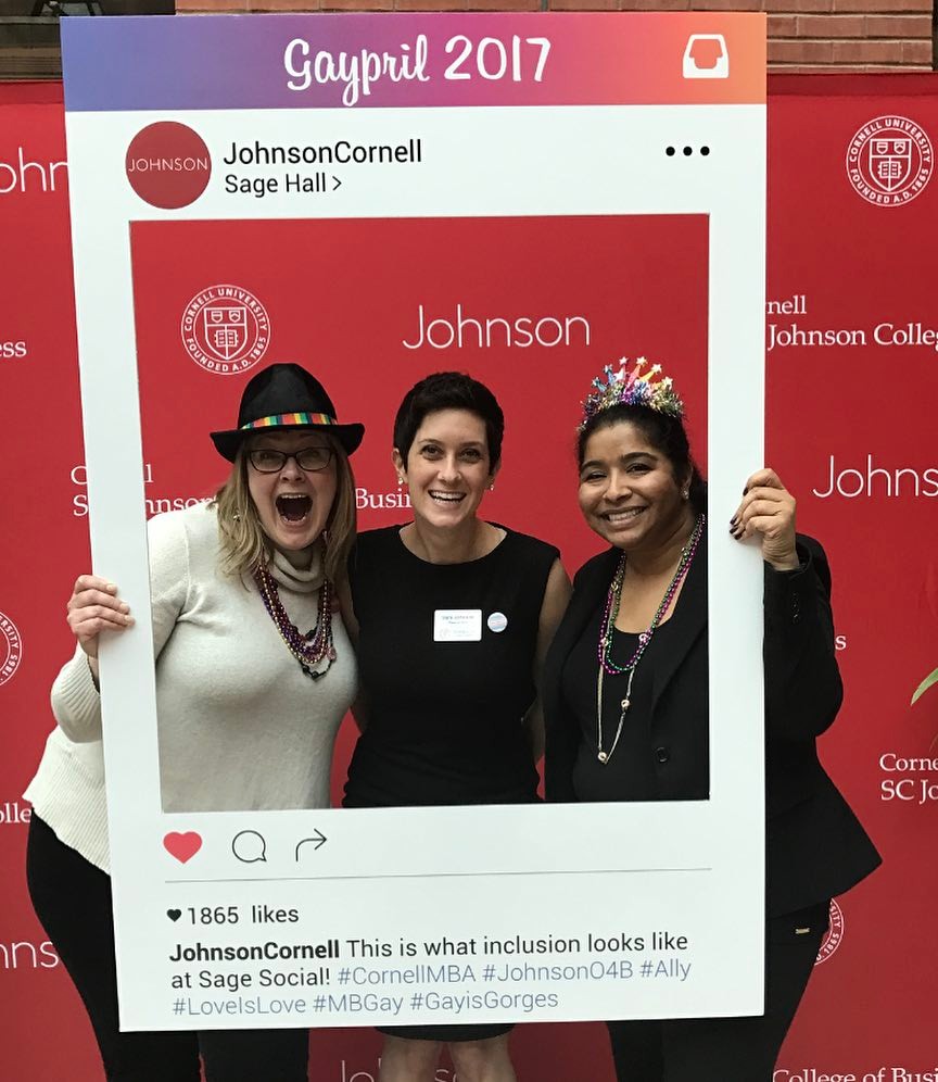 Photo of Chorben Miller, Recruiting Receptionist & Events Coordinator, Sarah Johnson, MBA '18, and Jamie Joshua, Director of the Office of Diversity and Inclusion, holding an Instagram frame in a photo booth at Gaypril 2017