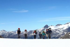 Photo of MBAs hiking up a snowy hills