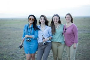 Photo of four MBAs after a safari in South Africa