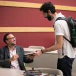 Photo of Damian Mogavero with a student at his book signing