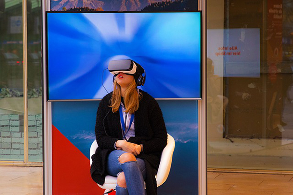 Photo of a women using virtual reality goggles
