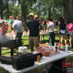 Nathan Ladovsky, MMH ’18, cooking hamburgers and hot dogs at Stewart Park