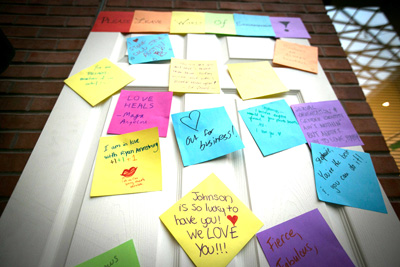 Photo of colorful Post-it notes on a white door at Johnson's Out for Business event