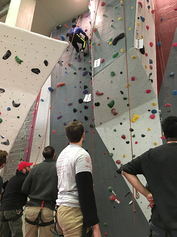 Photo of the Investment Banking Immersion students at the rockwall at the Lindseth Climbing Center