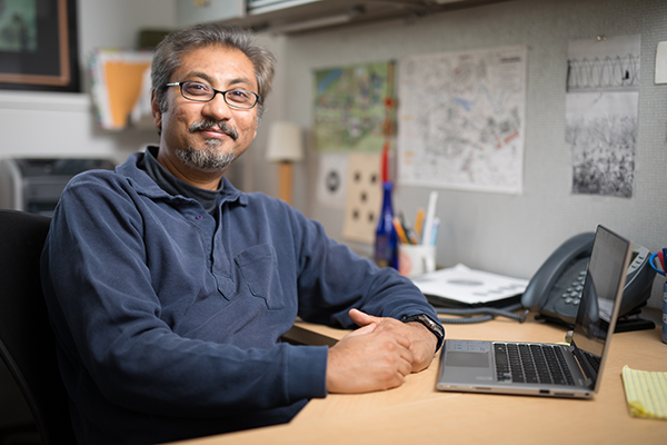 Portrait of Arnab Basu at his desk