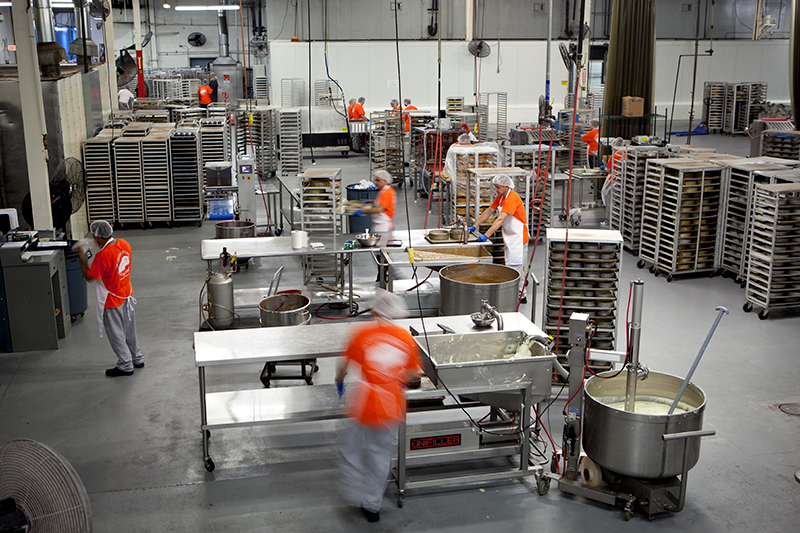 Photo of several people working in an industrial kitchen