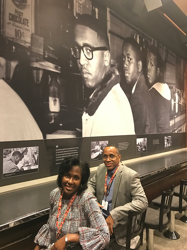 Photo of Lynn and David Wooten at the Woolworth’s Lunch Counter exhibit featuring photos of African Americans