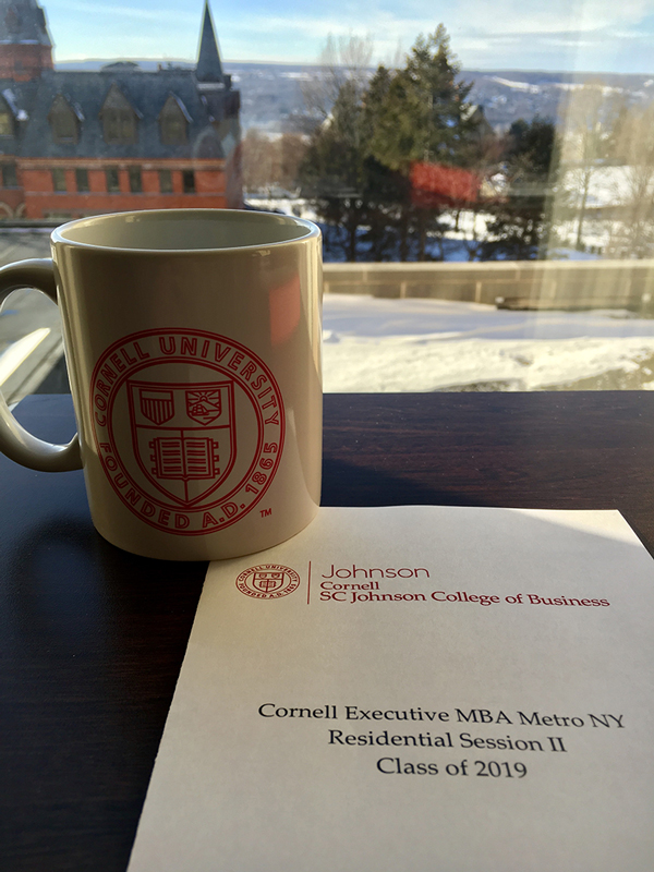 Photo of Cornell coffee mug, Sage Hall, and residence week brochure