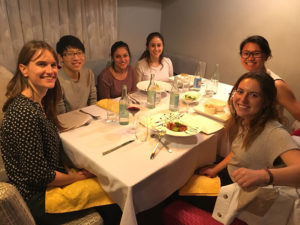 Photo of the group eating dinner around a table