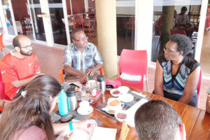 Photo of the group having a discussion around a table