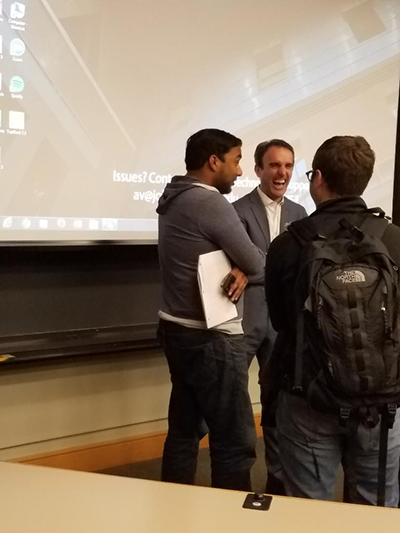 Photo of teammate Vinay laughing with professor Drew Pascarella