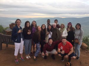Photo of students on a hill overlooking Pilanesberg National Park. 