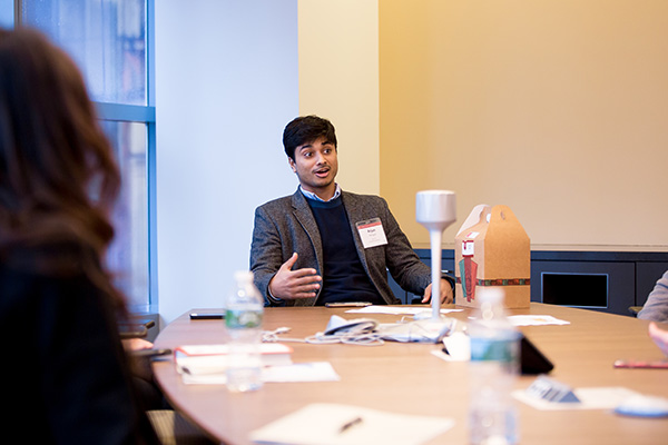 Photo of Arjun sitting at a table