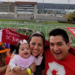 Photo of Abby, Cynthia, and Carlos at the Cornell Homecoming football game