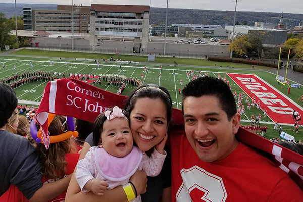 Photo of Abby, Cynthia, and Carlos at the Cornell Homecoming football game