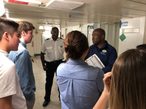 A photo of students listening to one of the workers