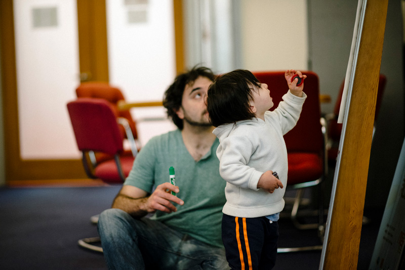 Photo of Greg and his son at a whiteboard