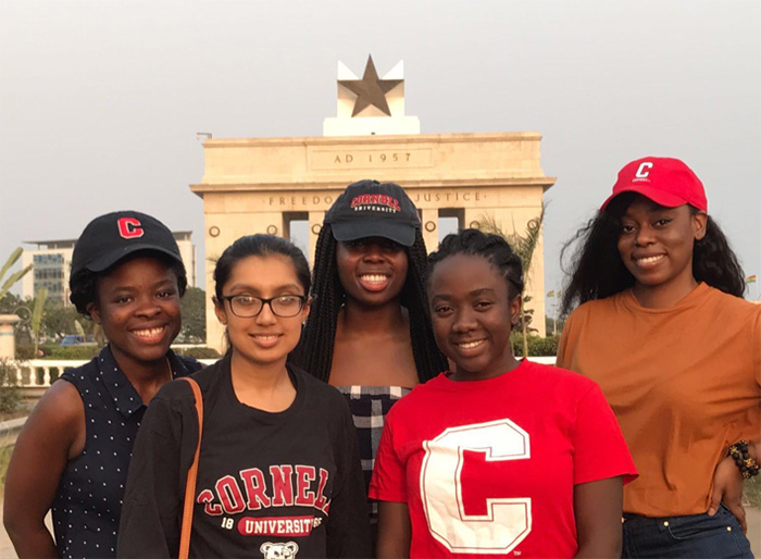 Photo of five students posed in from of the Independence Arch