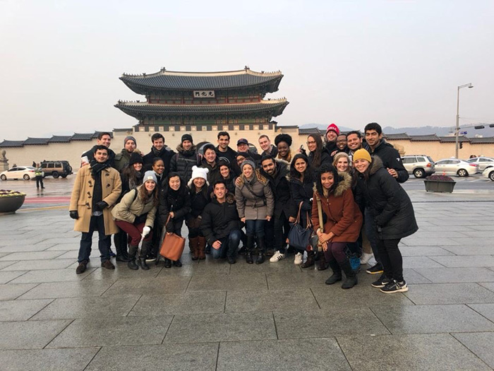 Photo of students on the trek in front of a traditional building