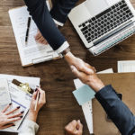 Photo of people shaking hands over a table