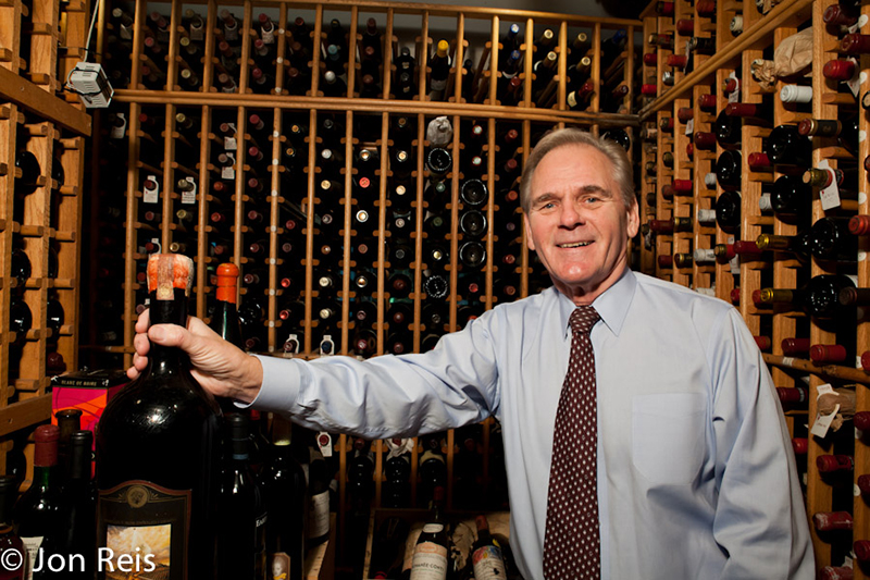 Photo of Mutkoski among several bottle of wine