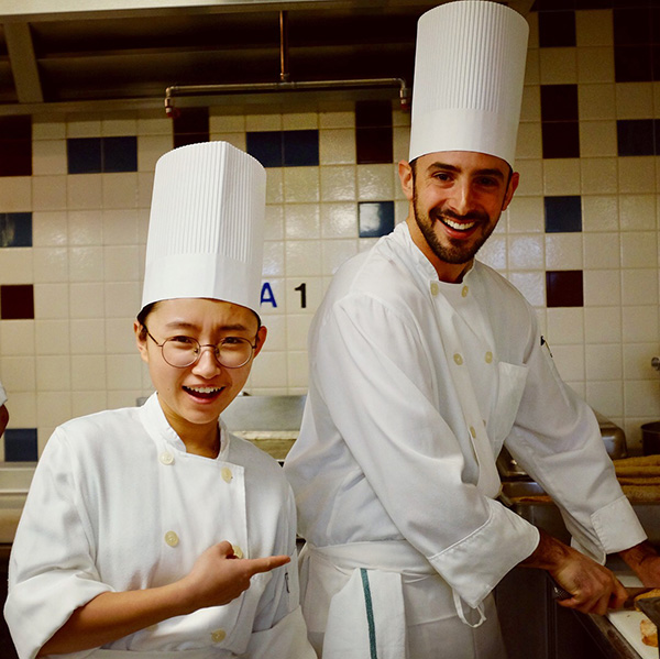 Photo of Nathan and a classmate wearing chef's hats