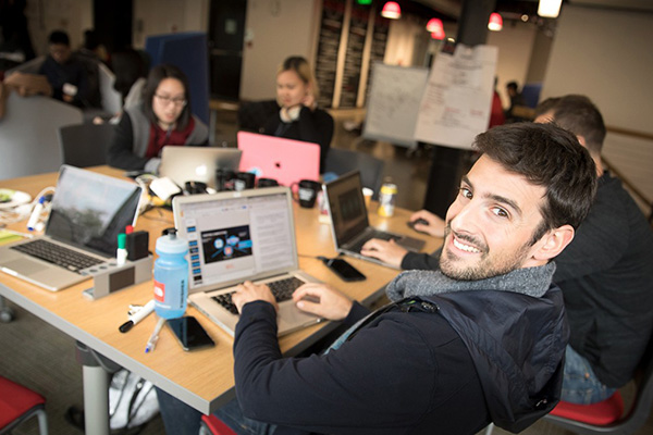 Photo of Nathan at his computer working