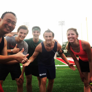 Photo of Nathan and his friends at Cornell's running track