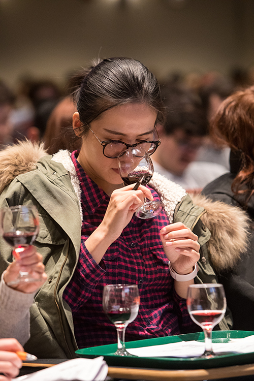 Photo of a student tasting red wine