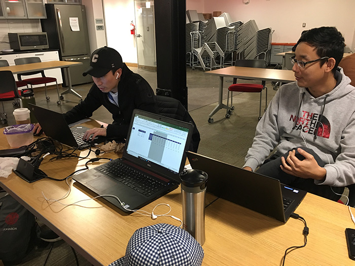 Brian's team working at a desk in ehub