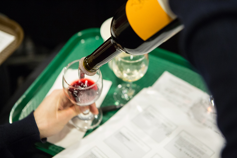 Photo of red wine pouring into a wine glass