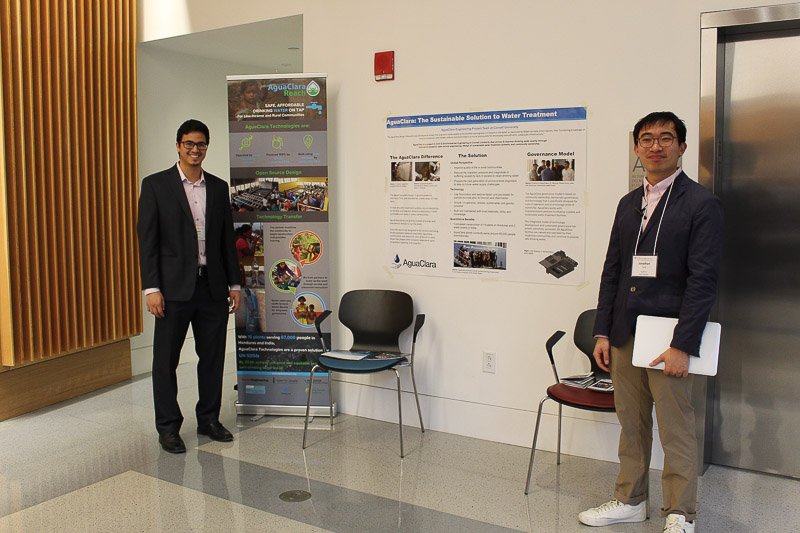 Photo of two students presenting their poster project
