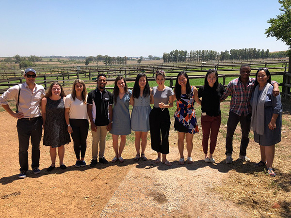 Photo of students standing in a row in a field