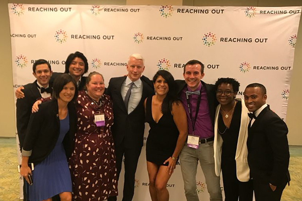 Photo of students with Anderson Cooper with a ROMBA backdrop