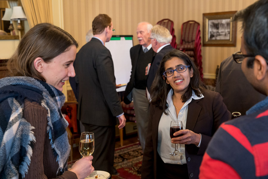 Photo of Anita speaking with attendees during a reception