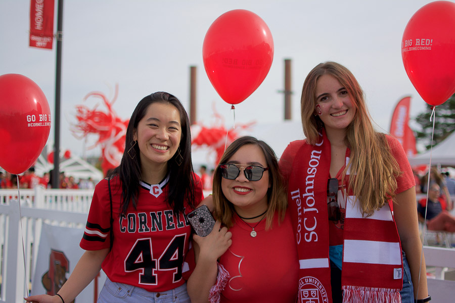 Photo of Eri and two other students wearing red for Cornell homecoming