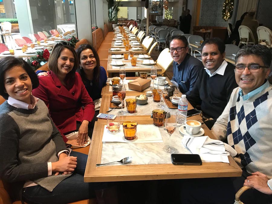 Photo of classmates sitting around a dining table