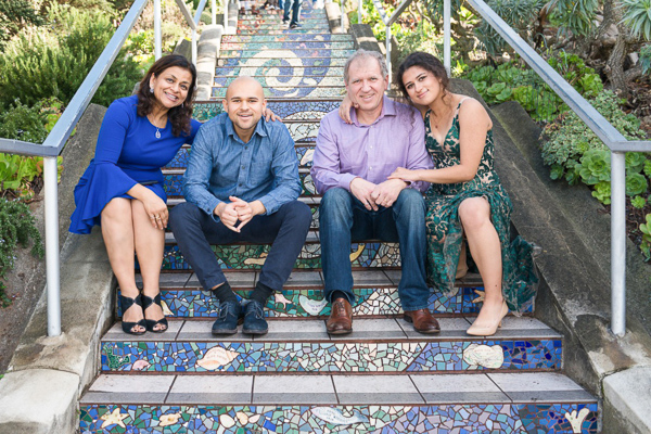 Photo of Diana with her son, husband, and daughter sitting on a staircase