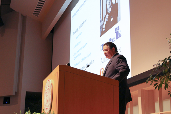 Photo of DAniello standing on stage at a podium