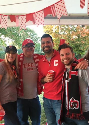 Photo of Nick and Katie with two others in Cornell gear