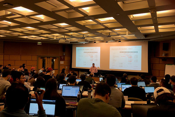 Photo of student sitting in a classroom for a presentation