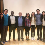Photo of Karpman standing with a group of students