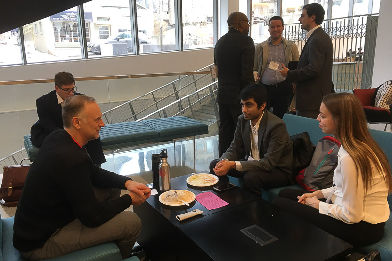 Photo of a group of students and speakers in the Breazzano Center atrium