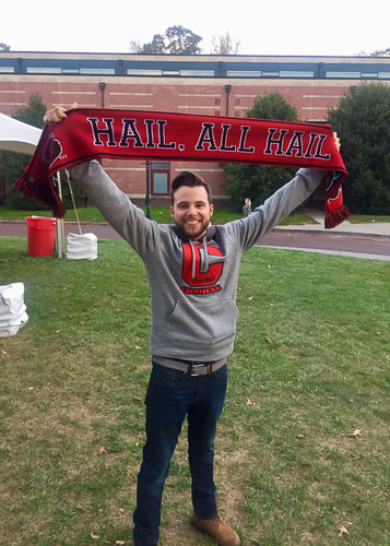 Photo of Nick with a Cornell sweatshirt and scarf